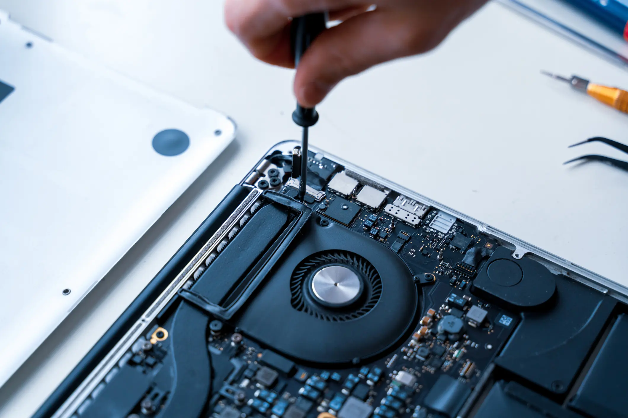Computer repair man. Pc technician service with laptop on hardware background. Maintenance engineer support. Electronic technology development concept.